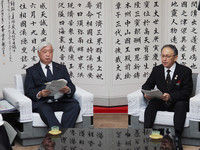 Japanese Defense Minister Gen Nakatani (left) meets with Okinawa Governor Denny Tamaki in Naha, the capital of Okinawa, on Sunday.