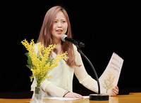 College student Sorane Sakihama speaks at a rally in the city of Okinawa on Sunday protesting sexual assaults by U.S. servicemen in Okinawa Prefecture.