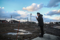 A man who lives near the Asaichi-dori morning market area, a major tourist spot in the Ishikawa Prefecture city of Wajima, prays for the victims of the Jan. 1, 2024, powerful Noto Peninsula earthquake, which also caused massive fires in the iconic market area.