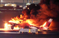 A Japan Airlines plane bursts into flames after a collision with a Japan Coast Guard aircraft at Haneda Airport in Tokyo on Jan. 2, 2024.