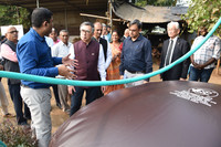 Suzuki Motor President Toshihiro Suzuki (front 2nd from left) inspects a dairy farm utilizing cow feces by placing them in a fermentation tank to extract methane gas, in Anand, Gujarat, western India, on Dec. 25, 2024.