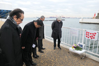 Passengers of the Diamond Princess cruise ship at the time of the February 2020 onboard outbreak of COVID-19 lay flowers on Monday morning at Daikoku Pier of Yokohama Port in Tsurumi Ward in the city of Yokohama, where the ship was moored.