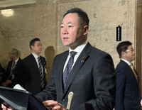 Justice Minister Keisuke Suzuki speaking at a press conference in the Diet building Tuesday