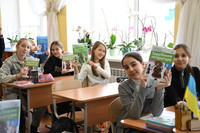 Students at a school in Irpin, Ukraine, hold up textbooks provided with the aid of Japan on Feb. 10.