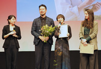 Japanese film director Satoko Yokohama (center right) expresses joy at the award ceremony of the Berlin International Film Festival in Berlin on Saturday.