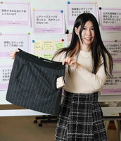 Ayako Urasawa demonstrates the inconvenience of women's clothing in Tokyo on Feb. 15.