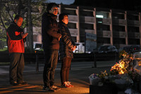 Student Hikaru Yamato's mother (right) and brother (center) mourn his death near the now-defunct Aso Ohashi bridge in the village of Minamiaso, Kumamoto Prefecture, on Wednesday.