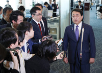 Japanese economic revitalization minister Ryosei Akazawa speaks to reporters at Tokyo's Haneda Airport on Wednesday.