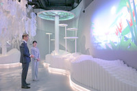 Princess Aiko (right) views an exhibit at the Singapore pavilion at the Osaka Expo on Friday. (Pool photo)