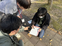 A student of the Faculty of Dinosaur Paleontology at Fukui Prefectural University (right) receives advice from a professor (second from left) in Eiheiji, Fukui Prefecture, on April 18.