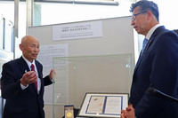 Toshiyuki Mimaki, an executive of the Japan Confederation of A- and H-Bomb Sufferers Organizations (Nihon Hidankyo), views replicas of the Nobel Peace Prize medal and diploma awarded to the group on display at the Hiroshima Peace Memorial Museum on Tuesday.