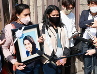 Wishma Sandamali's sisters, Wayomi (center) and Poornima (left), in Tokyo in April 2023