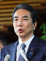 Taku Eto speaks to reporters after submitting his resignation as agriculture minister to the prime minister Wednesday.