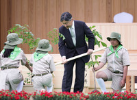 Emperor Naruhito plants seedlings at the 75th National Tree-Planting Festival at Chichibu Muse Park in Saitama Prefecture on Sunday.