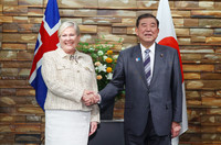 Japanese Prime Minister Shigeru Ishiba (right) shakes hands with Icelandic President Halla Tomasdottir at the prime minister's office in Tokyo on Tuesday.