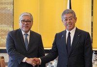 Japanese Foreign Minister Takeshi Iwaya (right) and his Philippine counterpart, Enrique Manalo, shake hands in Tokyo on Wednesday.