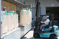 Stockpiled rice arriving at an Iris Ohyama group rice milling plant in the town of Watari, Miyagi Prefecture, on Thursday