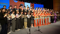 Japanese and Chinese university students sing in chorus at an exchange event held in Beijing on Thursday