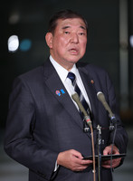 Prime Minister Shigeru Ishiba speaks to reporters after phone talks with U.S. President Donald Trump on Thursday.