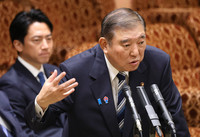 Japanese Prime Minister Shigeru Ishiba (right) speaks at the House of Councillors Budget Committee on Monday.