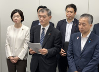 Former education minister Masahiko Shibayama (front center) from the ruling Liberal Democratic Party speaks to reporters after a working-level meeting among the LDP, its coalition partner, Komeito, and opposition Nippon Ishin no Kai (Japan Innovation Party) in Tokyo on Wednesday.