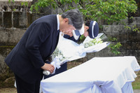 Emperor Naruhito, Empress Masako and their daughter, Princess Aiko, lay flowers on Thursday at a monument in Naha, Okinawa Prefecture, for the victims of the 1944 sinking of the Tsushima Maru evacuation ship.