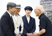Emperor Naruhito, Empress Masako, and their daughter Princess Aiko (from left) speak with Masakatsu Takara (far right) at the Tsushima-maru Memorial Museum in Naha, Okinawa Prefecture, on Thursday.