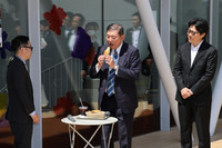 Japanese Prime Minister Shigeru Ishiba (center) on Saturday tastes pastries sold at Jins Park, a regional revitalization hub set up in Maebashi, the capital of Gunma Prefecture, by Japanese eyeglasses store chain Jins Holdings Inc.