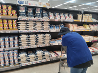 A customer looks at rice displayed on a shelf at a supermarket in Tokyo's Koto Ward on June 6.