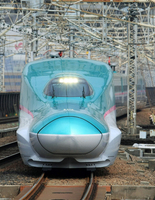 An E5 series Hayabusa bullet train traveling near Omiya Station on the Tohoku Shinkansen Line in March 2013