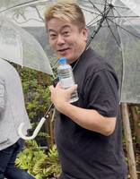 Takafumi Horie heading to the shareholders' meeting of Fuji Media Holdings Inc. in Tokyo on Wednesday morning.