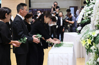 Bereaved people lay flowers at a memorial ceremony for the victims of the 2020 Kumamoto heavy rain disaster, in Hitoyoshi, Kumamoto Prefecture, on Sunday morning.