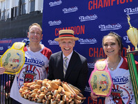 Miki Sudo (right) and Joey Chestnut (left), who won a hot dog eating contest in New York on Friday