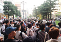 People listen to a speech by a candidate for the House of Councillors election in the city of Osaka on Friday.
