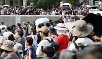 People carefully listen to stump speeches in Yokohama, Kanagawa Prefecture, Sunday, ahead of the July 20 election for Japan's House of Councillors, the upper chamber of parliament.