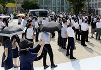 People listen to a street speech by a candidate for the Fukushima constituency in the House of Councillors election, in the city of Fukushima on July 3.
