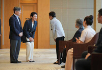 Emperor Naruhito and Empress Masako, on a state visit to Mongolia, talk with Japanese expatriates at a hotel in Ulaanbaatar on Wednesday. (Pool photo)