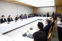 Japanese government officials discuss regional revitalization in a meeting at the prime minister's office in Tokyo on June 13.
