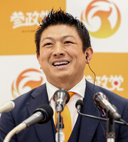 Sanseito leader Sohei Kamiya speaks to reporters in Tokyo on Sunday.