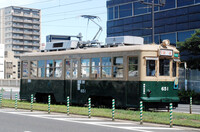 An atomic-bombed streetcar runs near the Atomic Bomb Dome in Hiroshima on July 27.