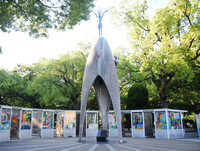 The Children's Peace Monument in the Peace Memorial Park in Hiroshima, western Japan, and paper cranes displayed around the statue