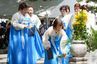 Attendees lay flowers to South Korean victims of the Aug. 6, 1945, U.S. atomic bombing of Hiroshima, at a memorial ceremony held at the Peace Memorial Park in the western Japan city on Tuesday.