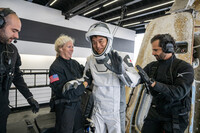 Takuya Onishi (second from right) waves at the camera after returning to Earth following a long-term stay at the ISS, off the coast of California on Saturday local time. (Courtesy of NASA)