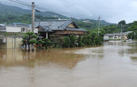 A house flooded above floor level in Tamana, Kumamoto Prefecture, on Monday.