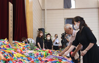 At a memorial ceremony in the northeastern Japan city of Akita on Thursday, people mourn the victims of the U.S.-led Allied powers' air raid on the city's Tsuchizaki district that lasted about four hours from around 10:30 p.m. on Aug. 14, 1945, the day before Japan's surrender in World War II. The attack is known as one of the last air raids on Japan during the war.