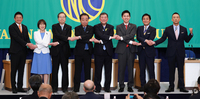 Leaders of Japan's ruling and opposition parties shake hands before a debate session hosted by the Japan National Press Club in Tokyo on July 2 (Pool photo)