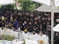 Attendees at a memorial ceremony pray Friday morning in Naha, Okinawa Prefecture, for victims of the sinking of the Tsushima Maru evacuation ship 81 years ago.