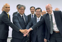 Ian Buck (front right), vice president at Nvidia, shakes hands with Riken President Makoto Gonokami (front second right) and others in Tokyo on Friday.