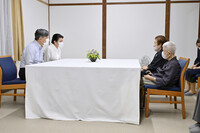 Emperor Naruhito and Empress Masako meet former Iwoto residents in Nasu, Tochigi Prefecture, on Tuesday. (Pool photo)